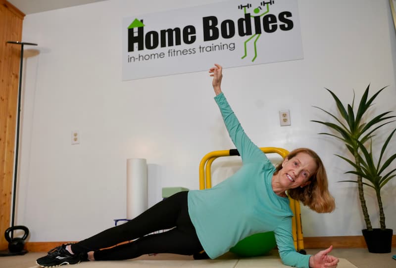 trainer demonstrating side plank corrective exercise